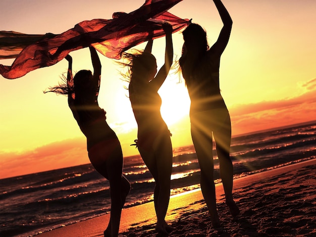 Premium Photo | Girls running on beach, having party at golden summer ...