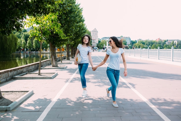 Free Photo | Girls walking on pavement holding hands