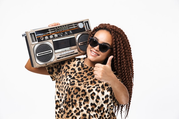 Premium Photo | Glamorous woman smiling and holding vintage boombox ...