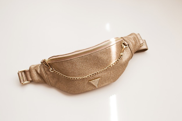 Premium Photo | Glamorous women's belt bag of golden color on a white