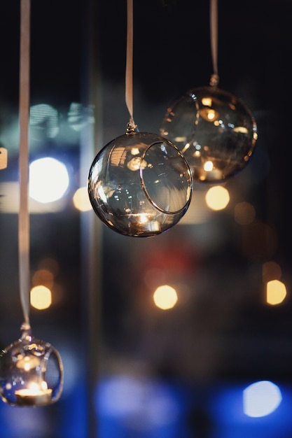 Glass Balls With Candles Hang Before The Window Photo Free Download 4446