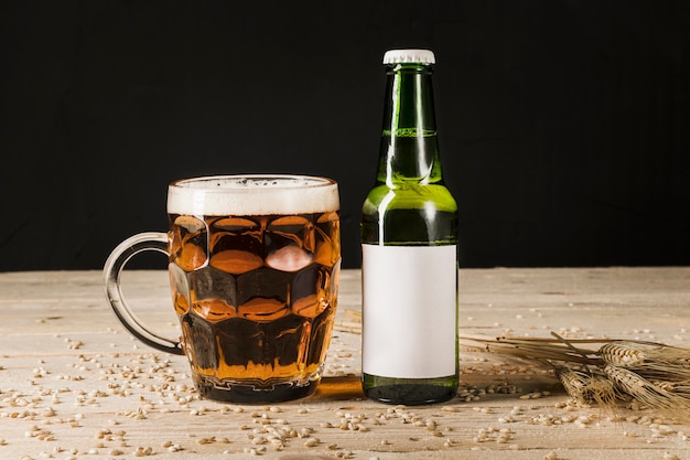 Free Photo | Glass of beer with green bottle and ears of wheat on ...