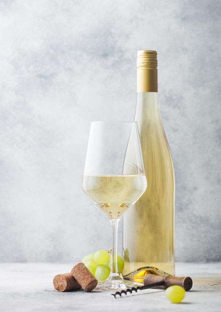 Premium Photo | Glass and bottle of white wine with grapes and