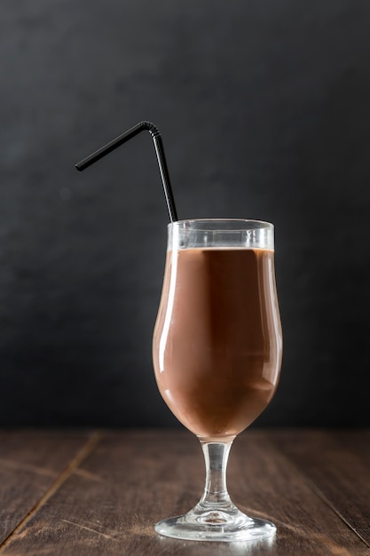 Free Photo | Glass of chocolate milkshake with straw and copy space