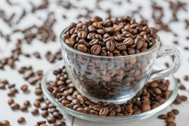 Premium Photo | Glass cup and saucer overflowing with lots of coffee ...