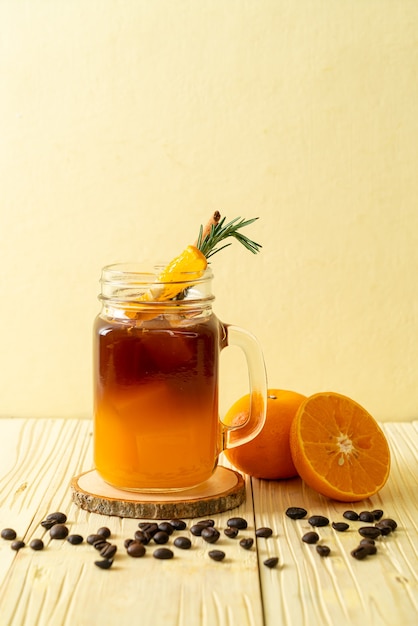 Premium Photo A Glass Of Iced Americano Black Coffee And Layer Of Orange And Lemon Juice 6146