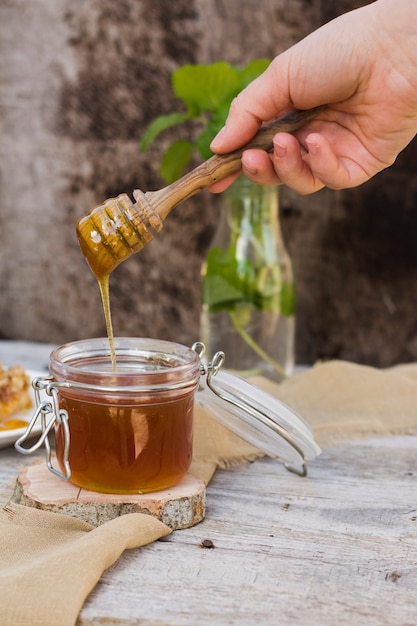 Free Photo Glass Jar Full Of Honey With Honey Spoon