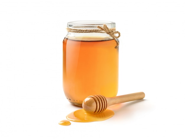 Premium Photo | Glass jar of pure honey with honey dipper isolated on