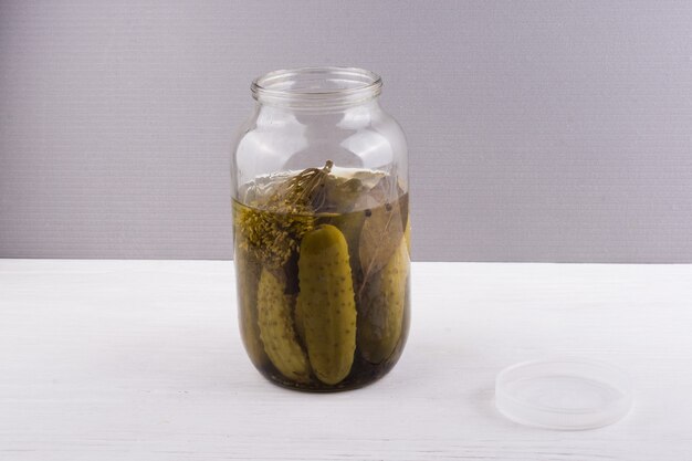 Premium Photo Glass Jar With Pickled Cucumbers On Gray Background