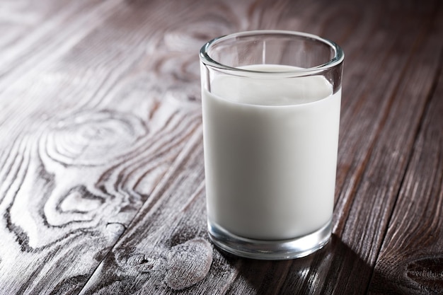 Premium Photo | Glass of milk on wooden table