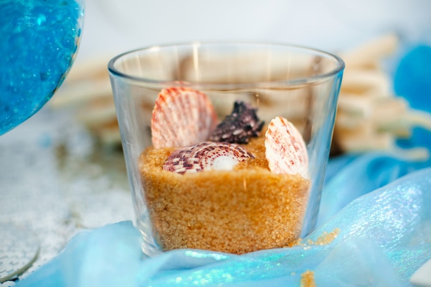 Glass Vase With Sweet Brown Sugar Sand And Difftent Seashells