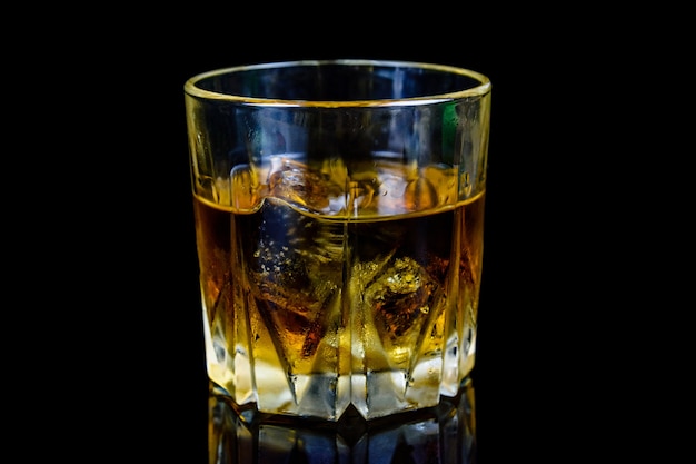 Premium Photo | Glass of whiskey isolated on the black background