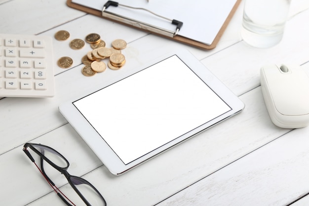 Glasses Calculator Coins And Tablet On White Neat Desk Photo