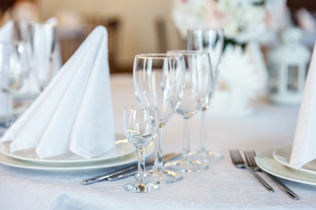 Glasses Fork Knife Napkin Folded In Pyramid Served For Dinner