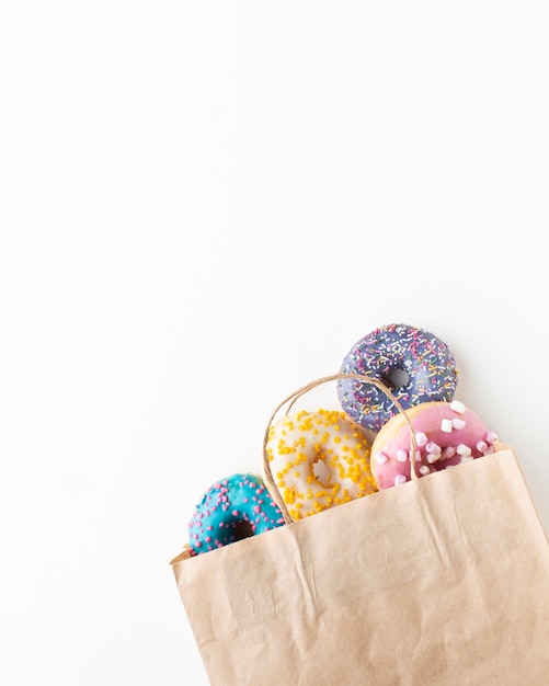 Download Glazed colorful donuts in paper bag | Free Photo