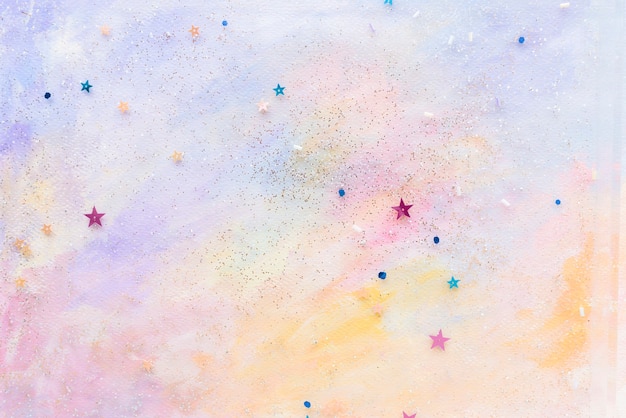 カラフルな抽象的なパステル水彩背景にキラキラ星の紙吹雪 無料の写真