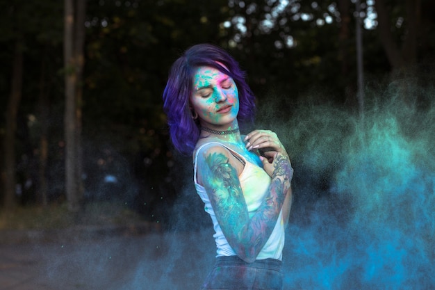 Premium Photo Glorious Young Woman With Purple Hair Posing With Exploding Holi Powder At The Park 