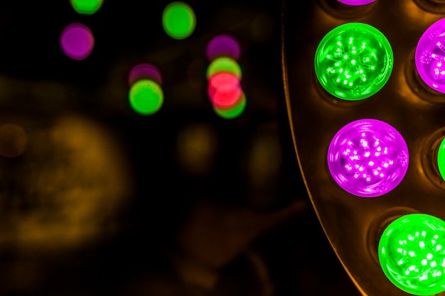 Glowing green and pink led bulb on background Free Photo