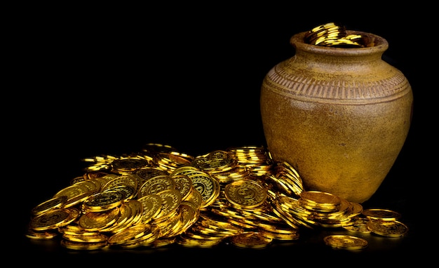 clay pot with gold coins and an old manuscript