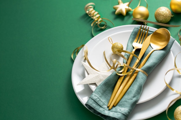 Gold cutlery served on plate for christmas dinner Free Photo