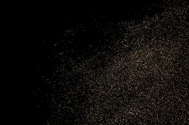 黒の背景に分離されたゴールドラメ粒子テクスチャ プレミアム写真