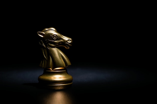 Premium Photo | Gold knight chess on black background