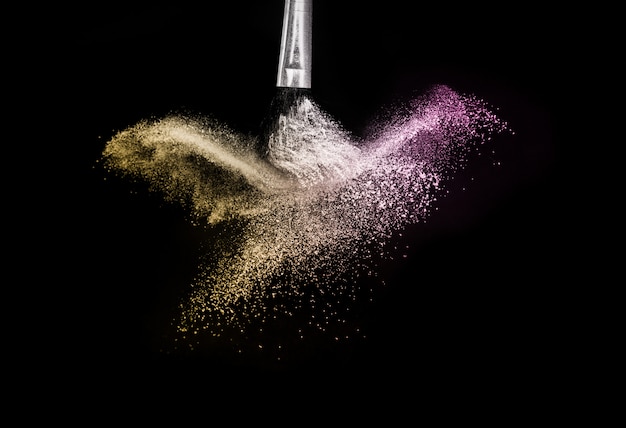 Gold and purple powder splash and brush Premium Photo