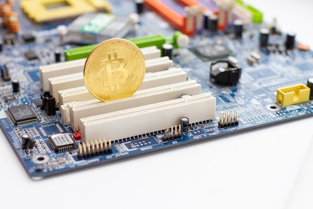 Premium Photo | Golden bitcoin on the circuit main computer board.