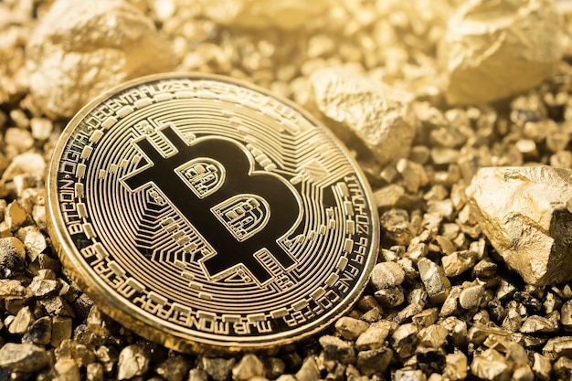 Golden bitcoin coin and mound of gold. bitcoin cryptocurrency. Premium Photo