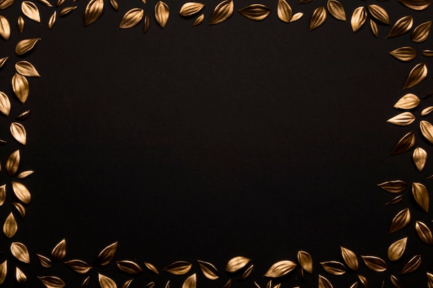 Free Photo | Golden leaves on black background copy space