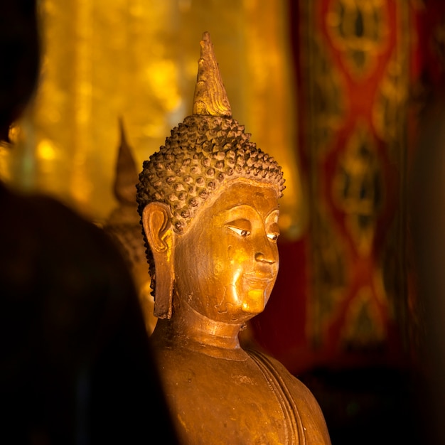 Premium Photo | Golden statue of buddha at wat phra singh, chiang mai ...