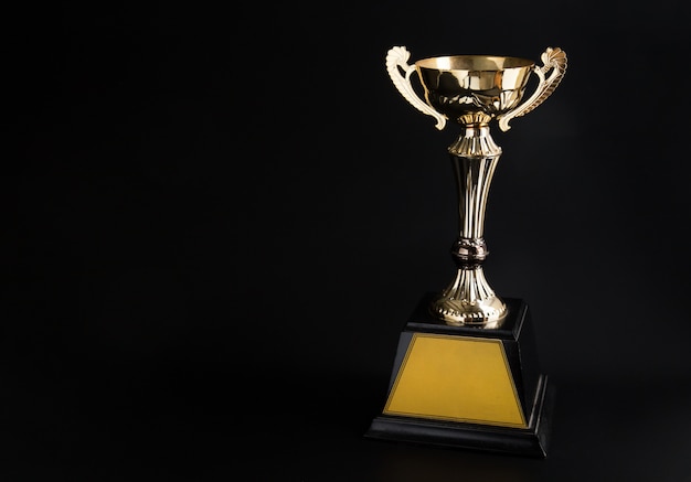 Premium Photo | Golden trophy over black background. winning awards ...