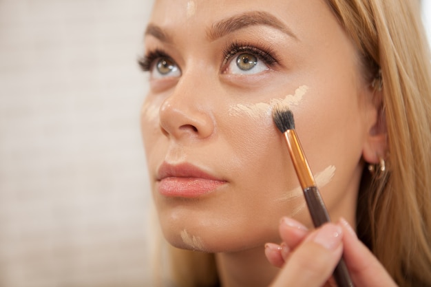 Gorgeous woman getting professional makeup Premium Photo