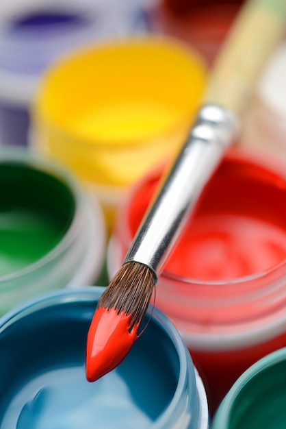 Premium Photo | Gouache paint jars and paintbrush