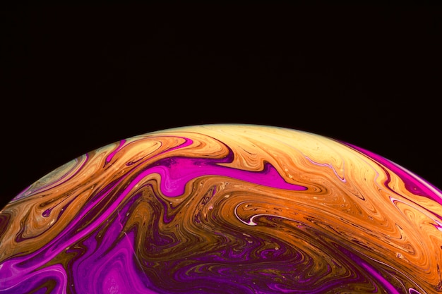 Free Photo | Gradient iridescent colorful soap bubble on black background