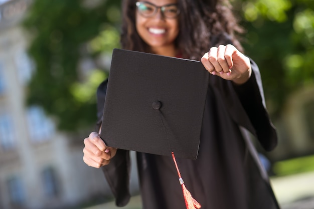 Premium Photo | Graduation. dark-haired graduate feeling happy and ...