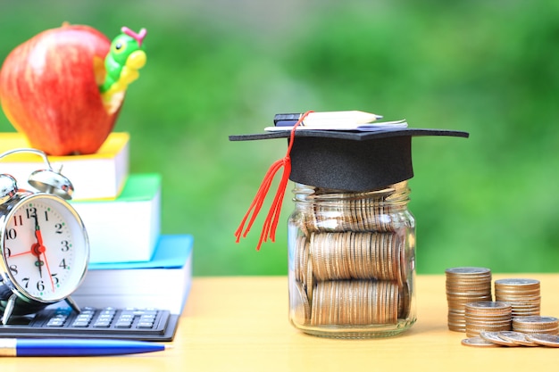 Graduation hat on the glass bottle and books Premium Photo