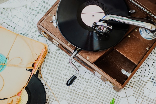 Premium Photo | Gramophone with a vinyl record on knitted tablecloth