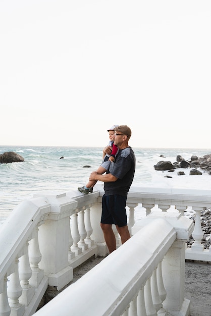 Download Free Photo Grandfather Holding Grandson And Looking At Sea