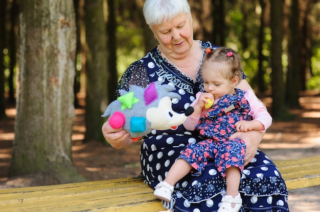 Premium Photo Grandmother And Granddaughter Walk In The Park