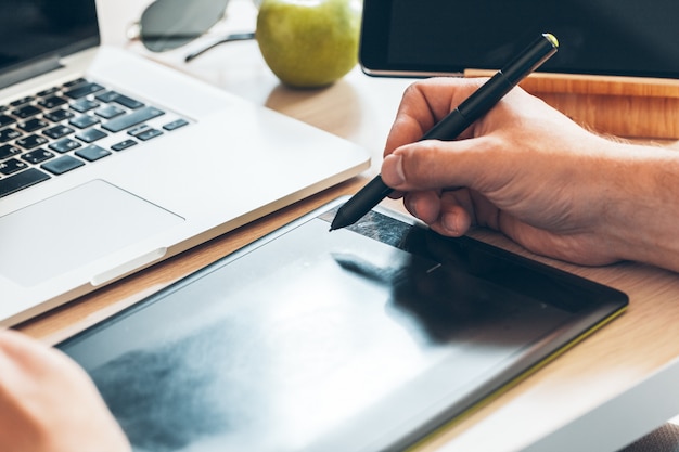 Graphic designer using a pen tablet Premium Photo