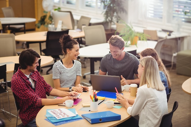 Five teachers having a conversation at a round table