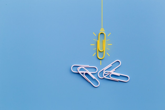 Great ideas concept with paperclip,thinking,creativity,light bulb on blue background,new ideas conce