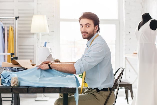 Premium Photo | Great mood. cheerful experienced tailor smiling and ...