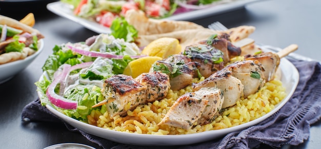 Premium Photo | Greek chicken souvlaki platter with pita bread, salad ...