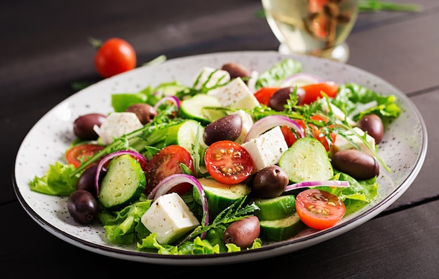 Greek salad with fresh vegetables, feta cheese and kalamata olives Free Photo