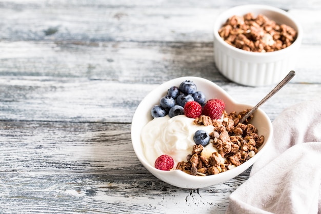 Premium Photo | Greek yogurt, blueberries, raspberries and granola in a ...