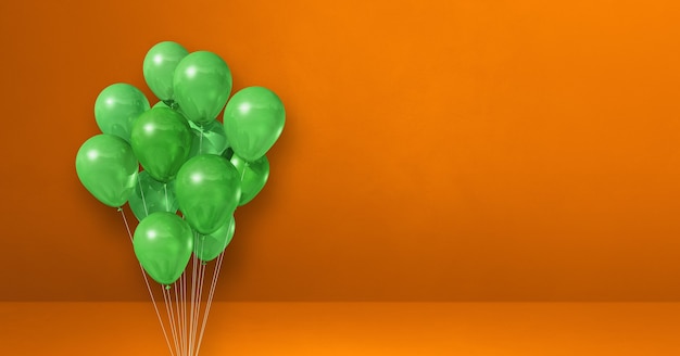 Premium Photo | Green balloons bunch on orange wall background ...