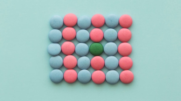 Free Photo | Green candy arranged in the pink and blue candies on ...