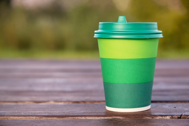 Download Premium Photo Green Cardboard Cup With Plastic Lid For Coffee On Wooden Background Or Surface Mockup Close Up